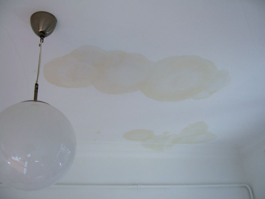 Tile roof leak repair in Arizona showing water intrusion damage and repair work in progress