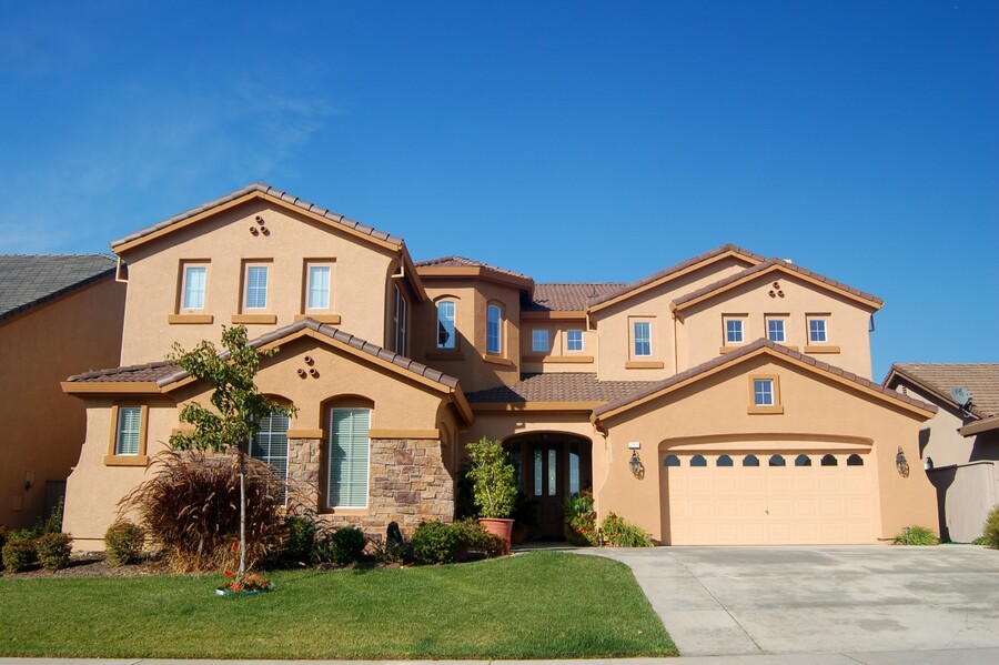 Two-story Arizona home with concrete tile roof under clear blue sky