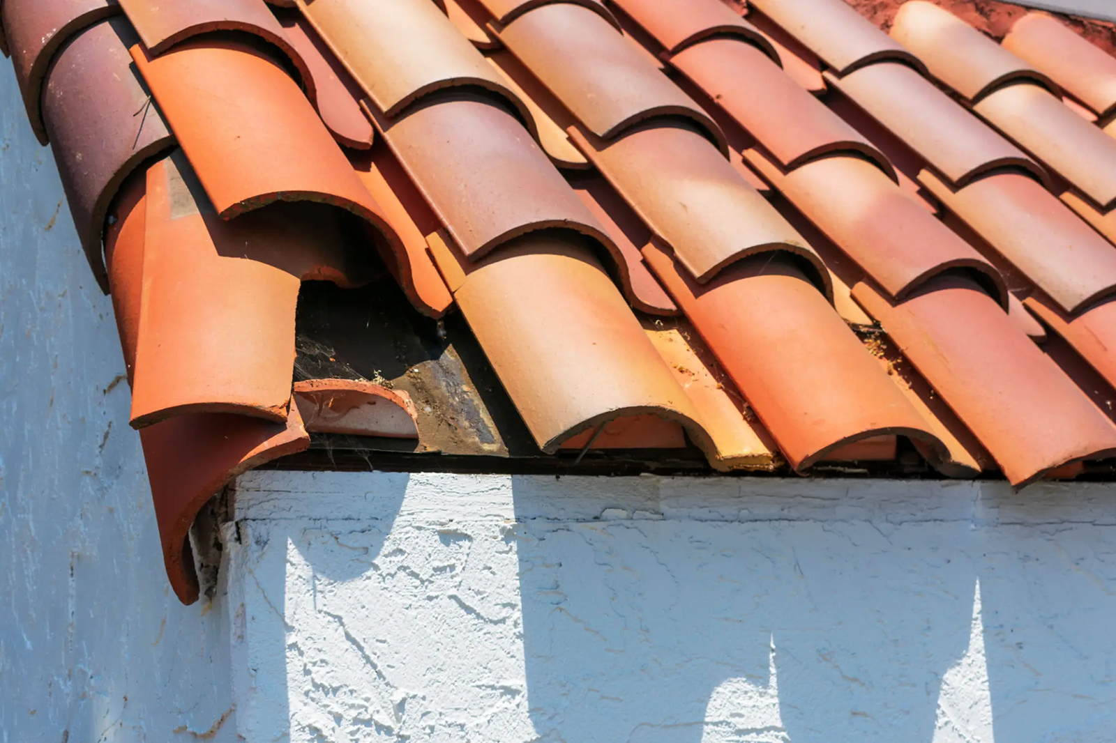 Cracked and displaced tile roof showing damage that can lead to leaks in Arizona homes