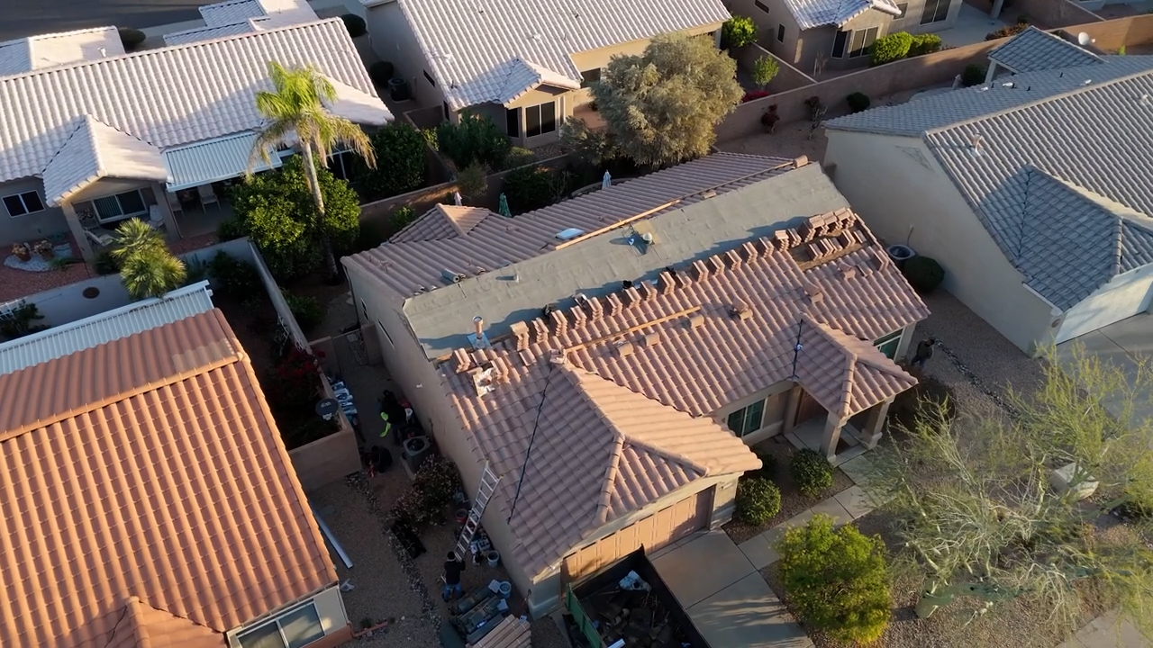Roof deck inspection during tile roof replacement in Sun City Arizona showing exposed decking