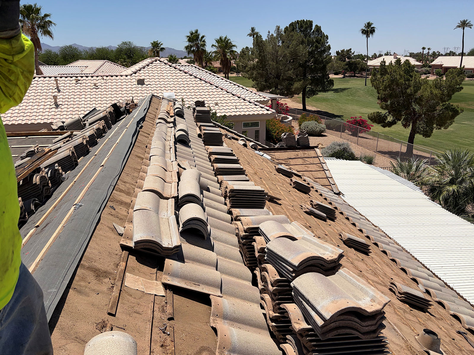 Sun City Arizona tile roof underlayment replacement project with concrete roof tiles removed during residential reroofing process