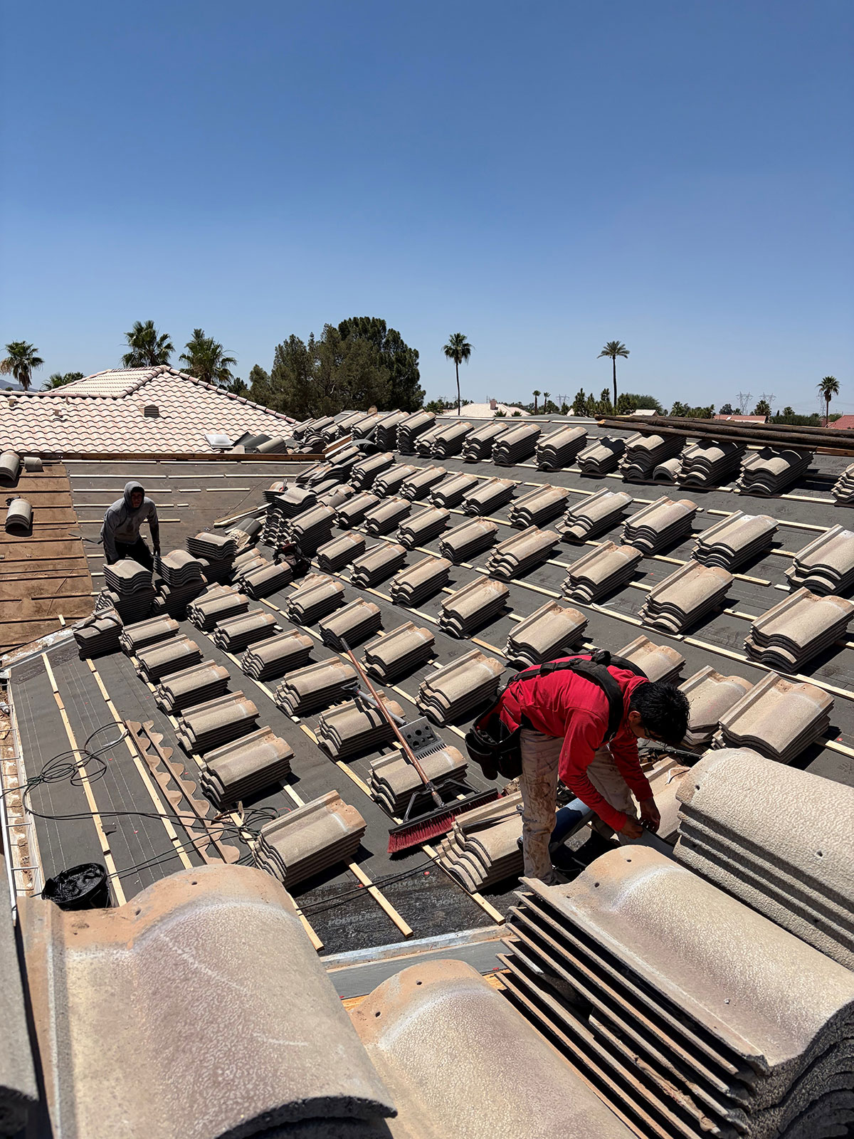 Roof Fix AZ crew performing tile roof underlayment replacement on residential home in Sun City Arizona