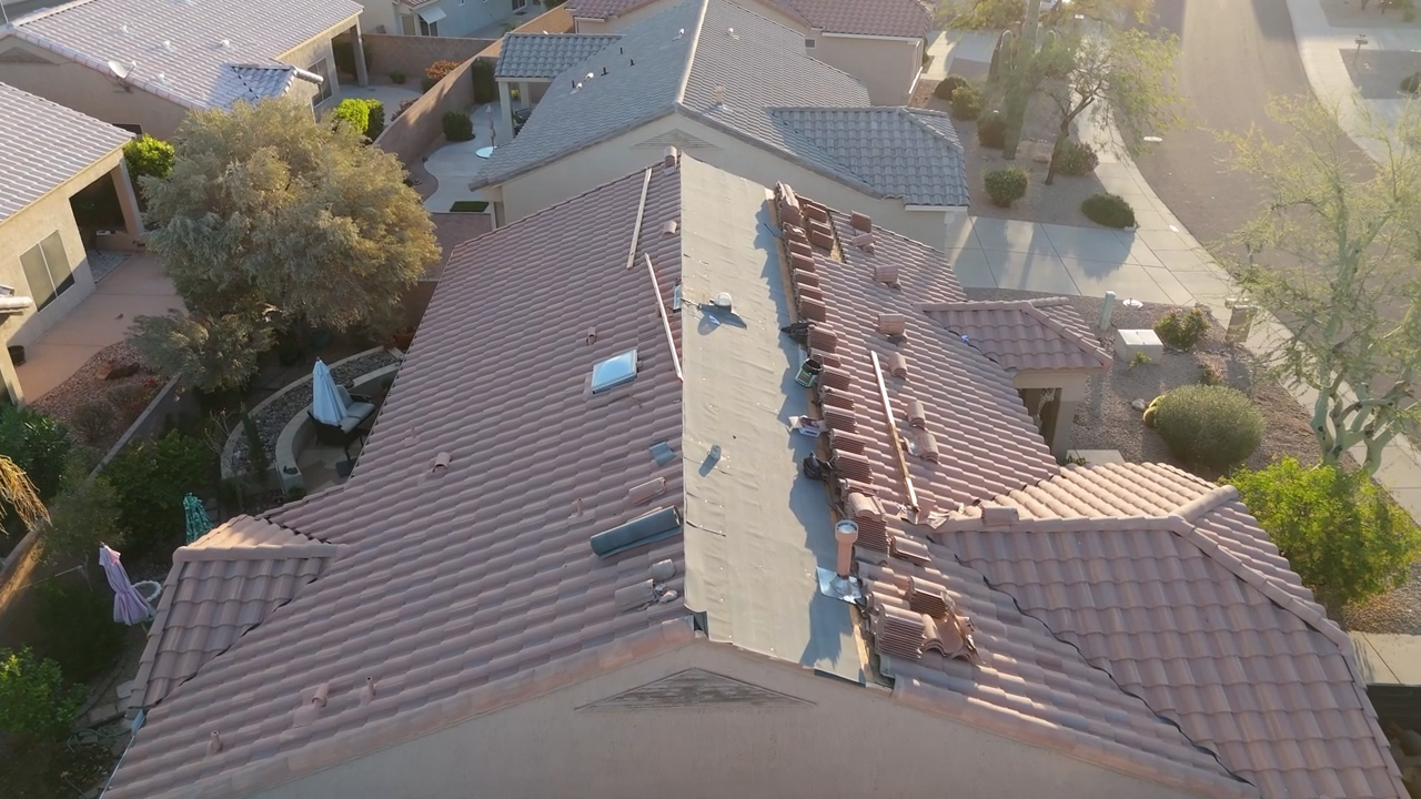 Tile roof underlayment installation in Sun City Arizona showing waterproof barrier being applied